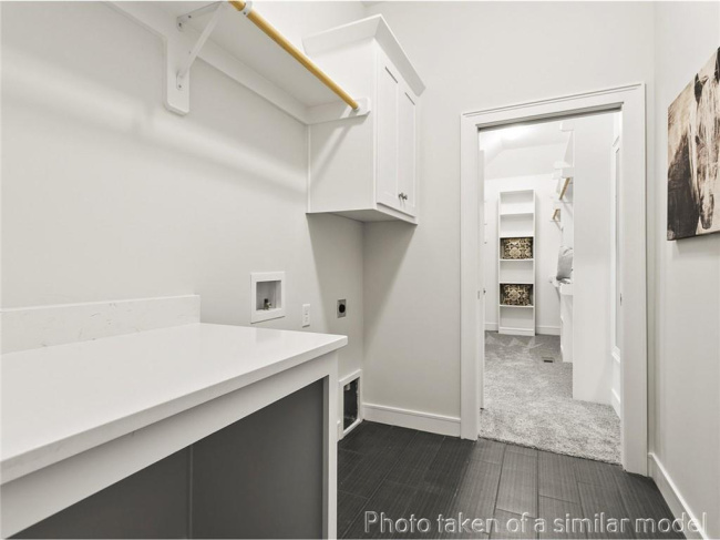 Laundry area featuring cabinet space, washer hookup, and electric dryer hookup