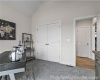 Home office with carpet and lofted ceiling