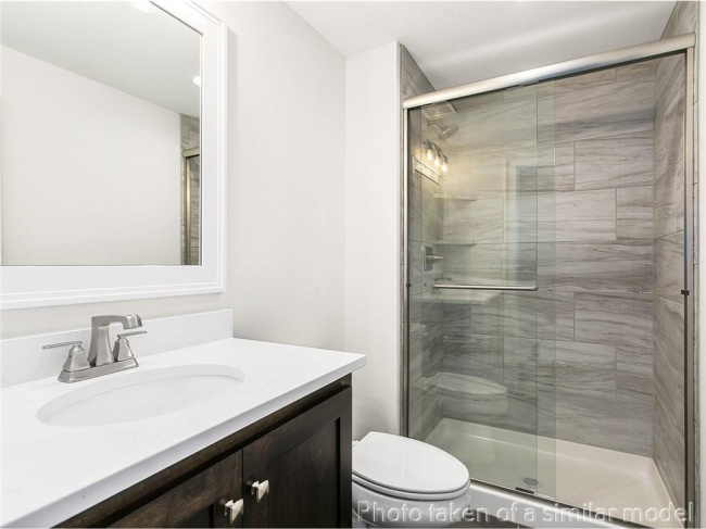 Bathroom with vanity and a shower stall