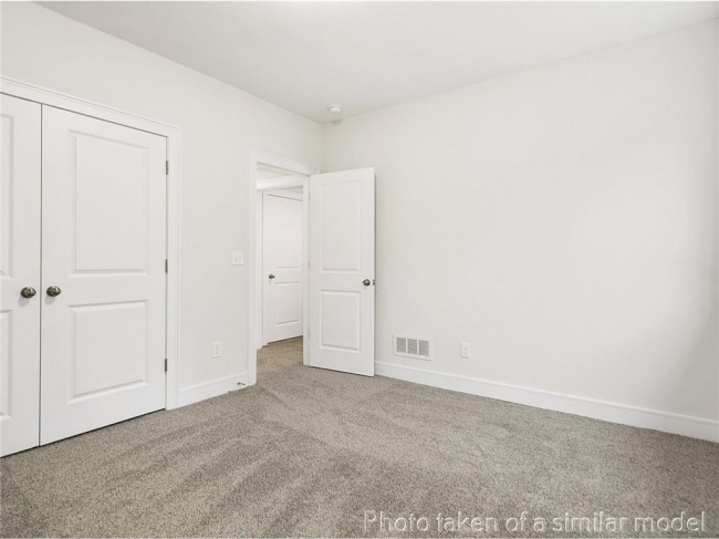 Unfurnished bedroom featuring carpet flooring and a closet