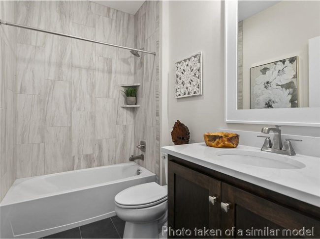Full bath featuring vanity, tile patterned flooring, and bathing tub / shower combination
