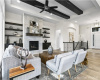 Living room featuring recessed lighting, wood finished floors, a ceiling fan, a premium fireplace, and beamed ceiling