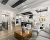 Living area featuring a raised ceiling, a chandelier, light wood-style floors, and recessed lighting