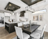 Dining area featuring light wood-style floors, a chandelier, recessed lighting, and a tray ceiling